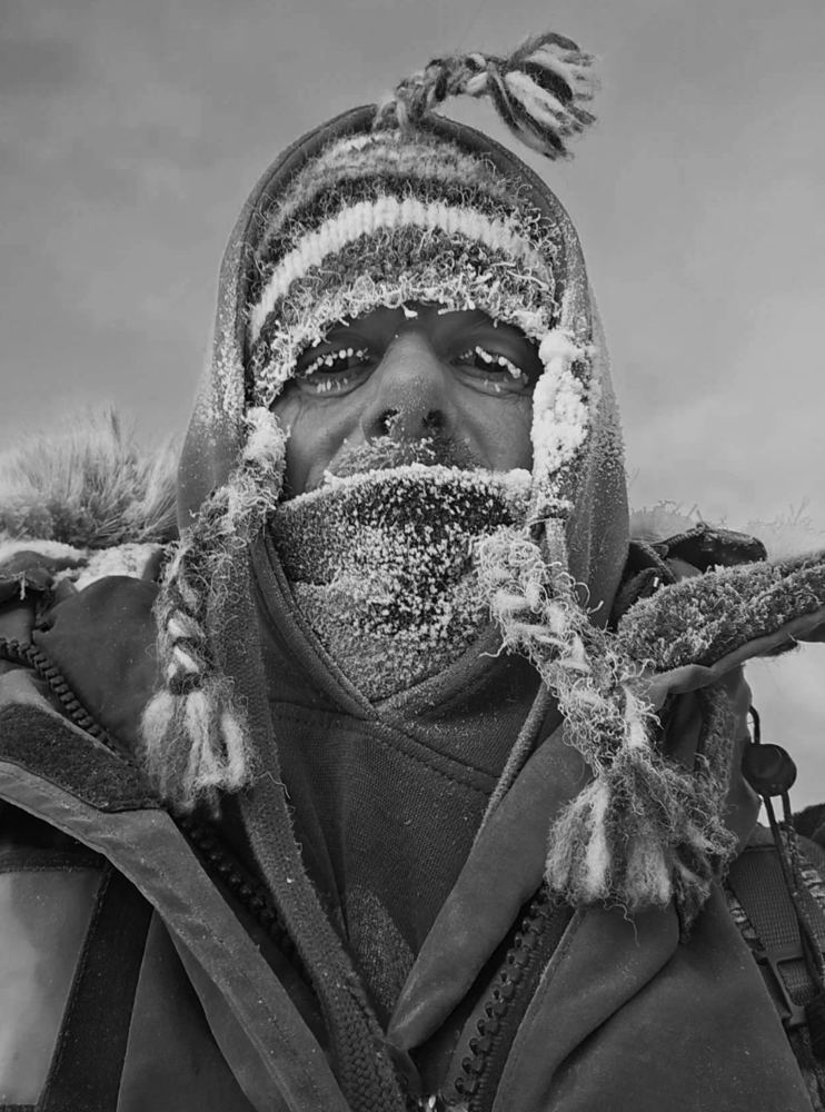 Bertrand, his face covered in frost, in cold-weather gear in the Yukon